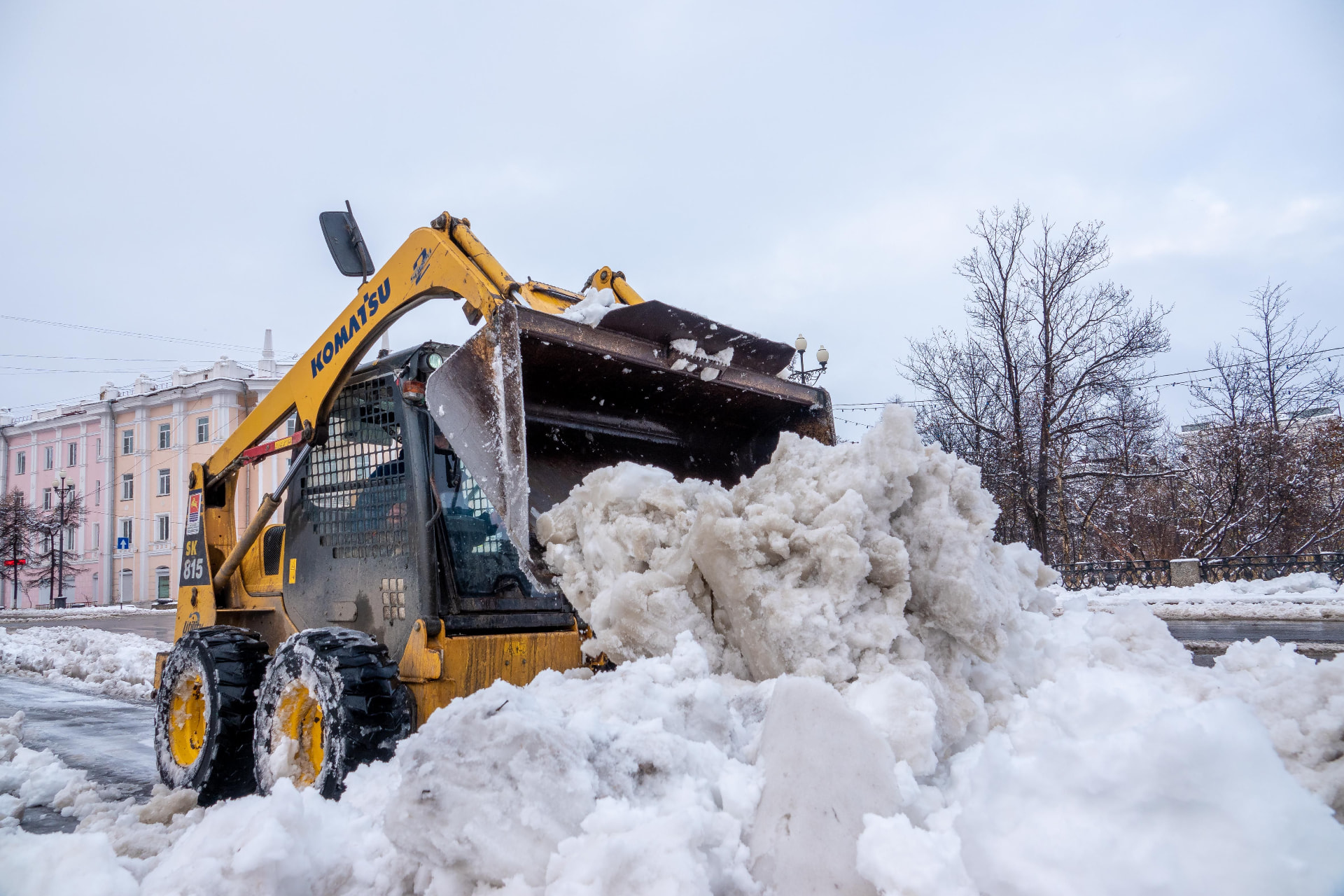 Skid steer clearing a commercial snow pile in Central Massachusetts